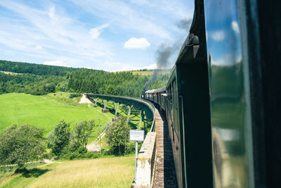 Panoramic view of train on field against sky on a viaduct