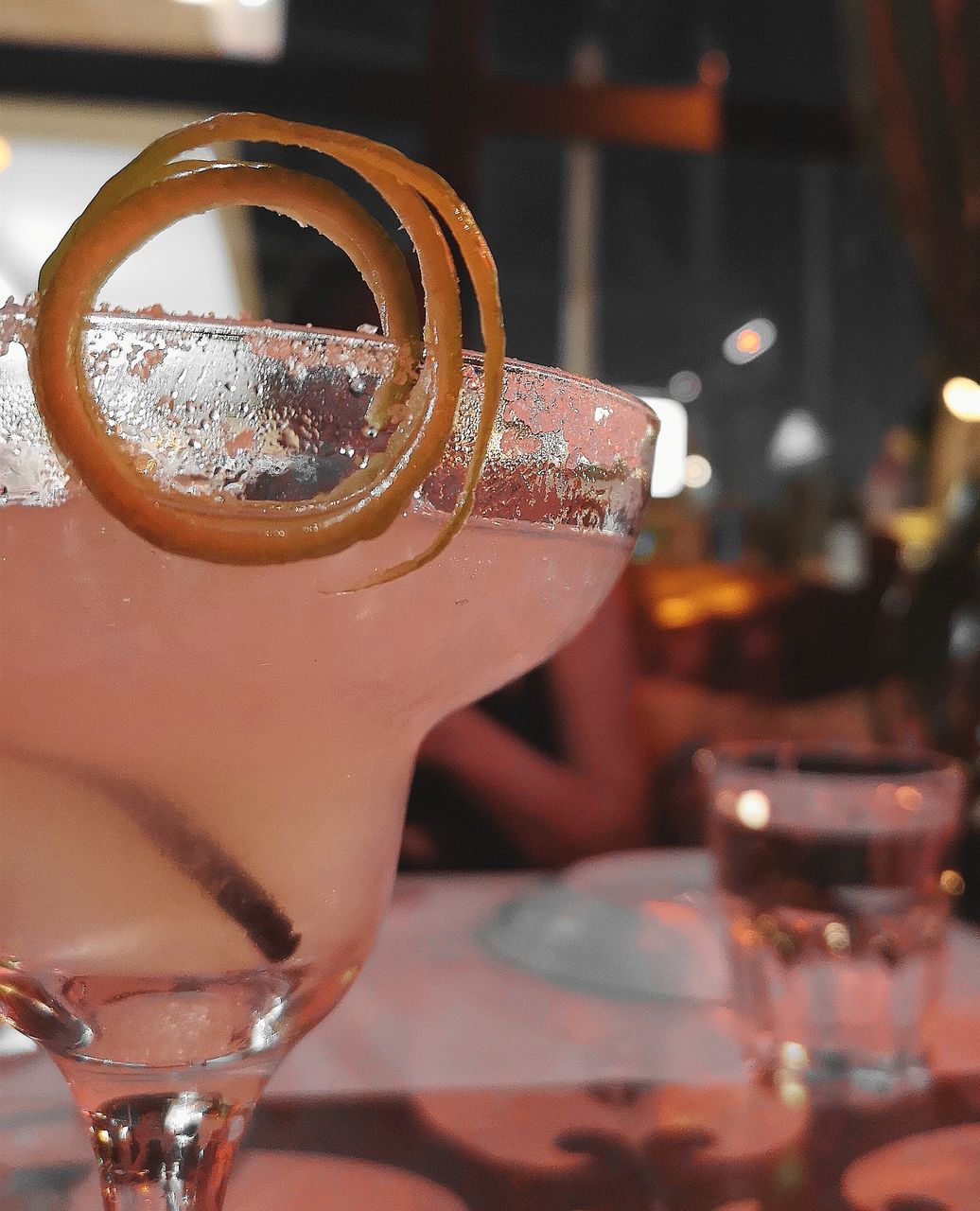 CLOSE-UP OF BEER GLASS ON TABLE