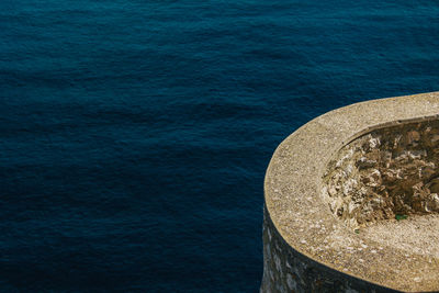 High angle view of retaining wall by sea