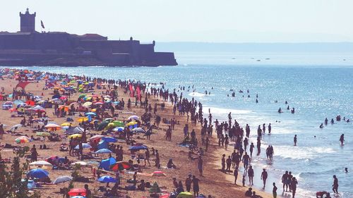 High angle view of people enjoying at praia de carcavelos beach