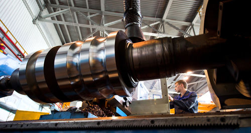 Low angle view of male worker working in factory