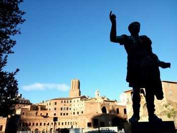 Low angle view of statue against clear blue sky