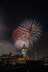 Low angle view of firework display at night