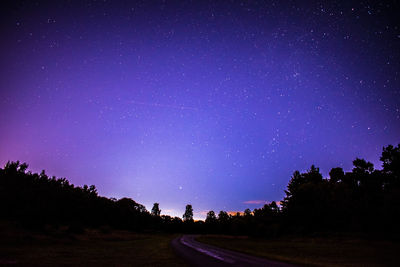 Scenic view of landscape against sky at night