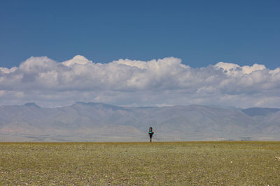 Rear view of man hiking in the step of kosch agach, russia against sky