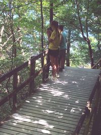 Rear view of woman walking in forest