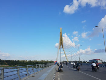 Bridge over road against blue sky