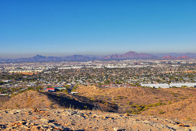 Aerial view of townscape against clear blue sky