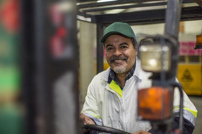 Worker sitting in forklift