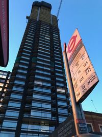 Low angle view of communications tower against sky