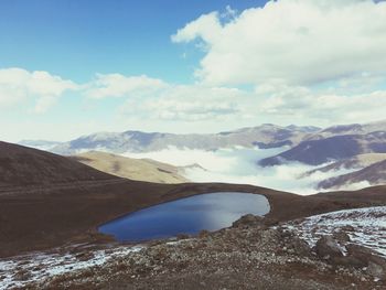 Scenic view of lake and mountains against sky