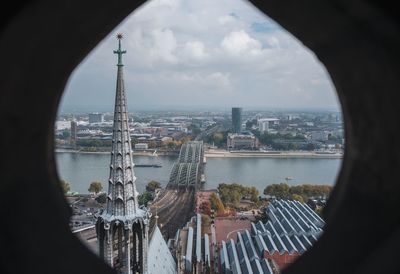 Aerial view of city against cloudy sky