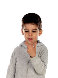 Portrait of boy standing against white background