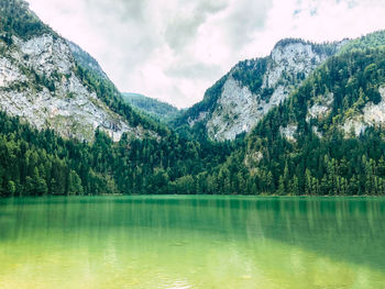 Scenic view of lake and mountains against sky