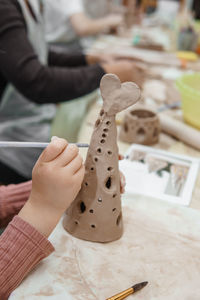 Women's hands knead clay, drawing elements of the product. production of ceramic products. 