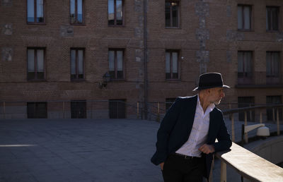 Portrait of adult man in hat and leather jacket on street. madrid, spain