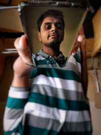 Portrait of young man holding camera