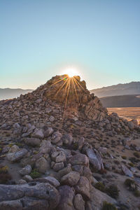 Rock formation against sky during sunset