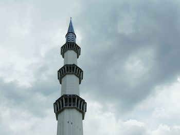 Low angle view of sultan salahuddin abdul aziz mosque minaret against cloudy sky