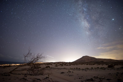 Scenic view of desert against sky at night