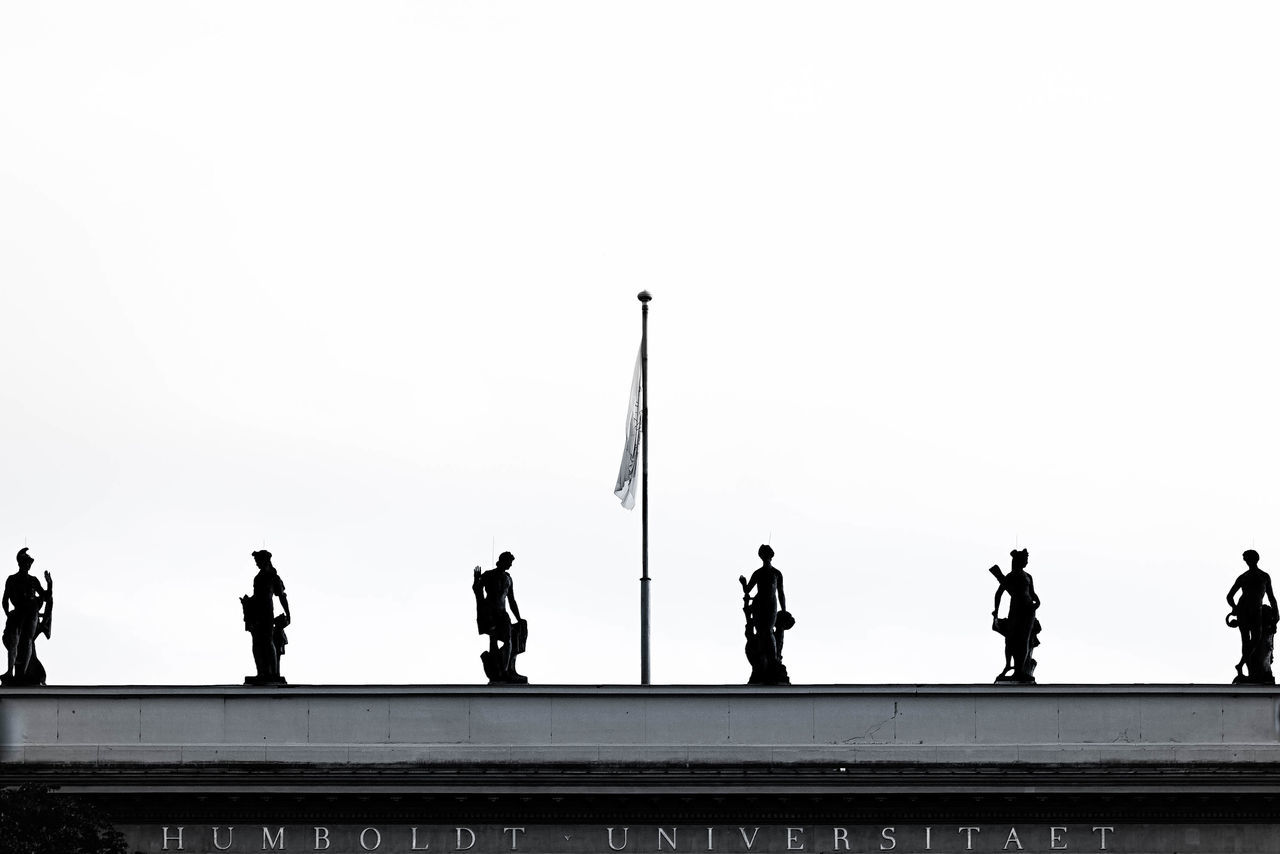 GROUP OF PEOPLE WALKING ON BRIDGE