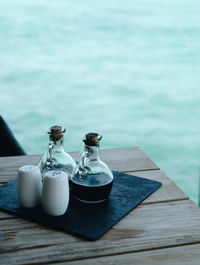 Close-up of ice cream on table by pier against lake