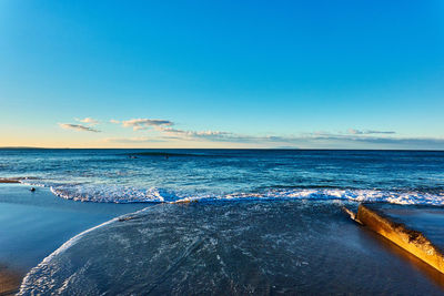 Scenic view of sea against blue sky