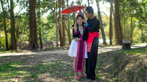 Full length of a girl standing in forest