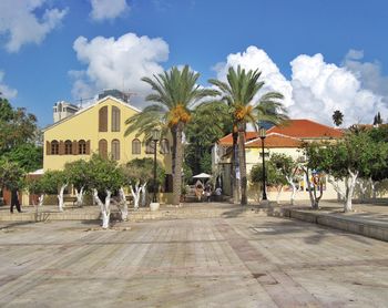 Buildings against cloudy sky