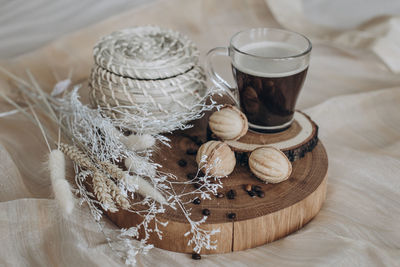 Still life cup coffee with cookies nuts on a wooden stand top view