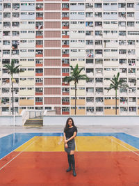 Portrait of woman standing by swimming pool