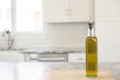 Close-up of oil bottle on table