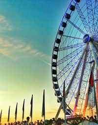 Low angle view of ferris wheel against blue sky