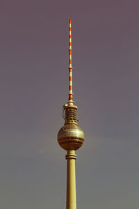 Low angle view of communications tower against sky at night