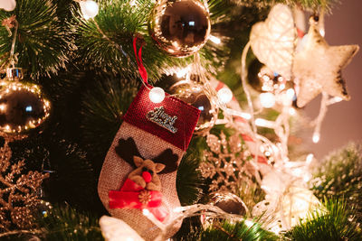 Close up of christmas tree decorated with lights at home. christmas concept indoors