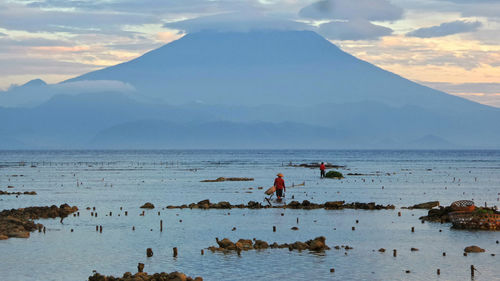 People on beach against sky