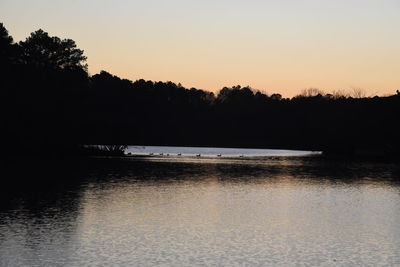 Scenic view of lake against sky during sunset