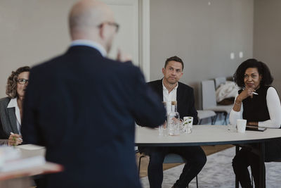 Business people brainstorming during meeting at education class