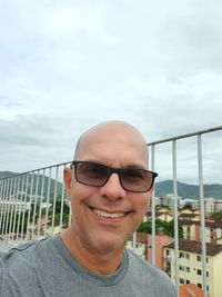 Portrait of smiling man against sky