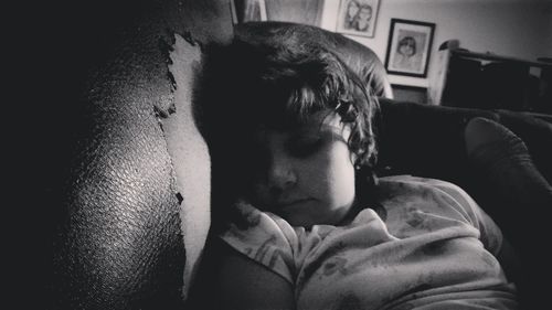 Portrait of young man resting on sofa at home