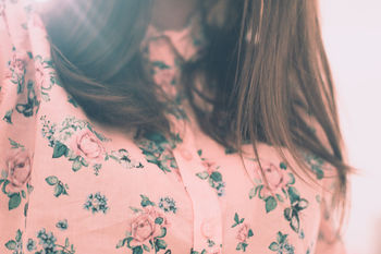 Midsection of woman wearing floral shirt