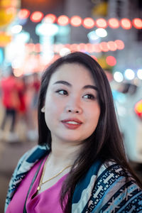 Portrait of smiling young woman standing outdoors