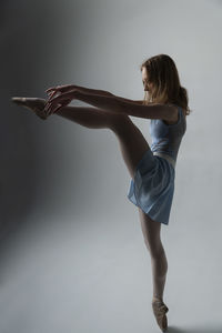 Ballet dancing against gray background