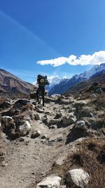 Women standing on mountain against sky