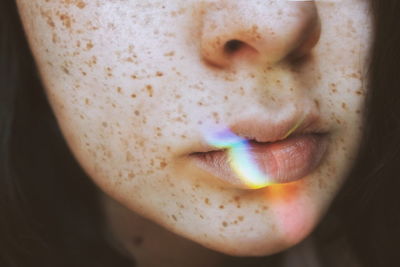 Close-up of spectrum on woman lips