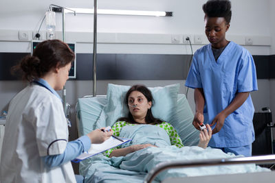 Female doctor examining patient in hospital