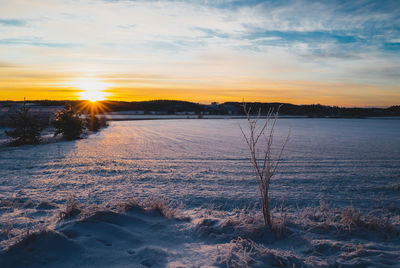 Scenic view of lake against sky during sunset