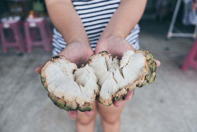 Low section of woman holding ice cream