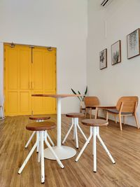 Empty chairs and table against wall at home