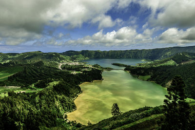 Scenic view of mountain and sea against sky